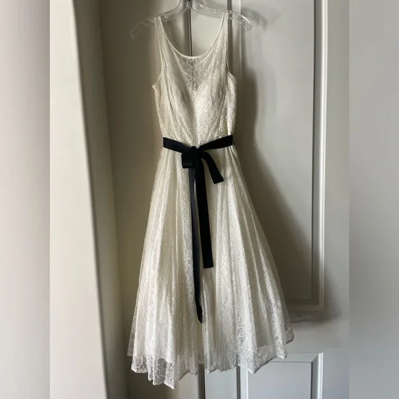 White lace dress with grosgrain bow. Only been worn once. White lace dress with grosgrain bow. Only been worn once.